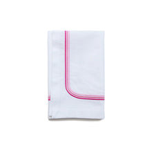 Load image into Gallery viewer, A white cotton napkin with three pink embroidered lines on the edge, neatly folded.