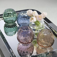 Load image into Gallery viewer, A collection of multipurpose optic vases in various colors including green, blue, clear, brown , and pink, with a textured design, displayed on a mirrored tray with flowers in the clear vase.