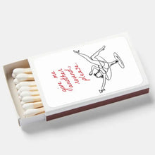 Load image into Gallery viewer, White matchbox with a black -colored illustration of a person in a champagne glass. "give me another round, please." in  red cursive text. Matchbox is opened with white tipped matches inside.  On a white background