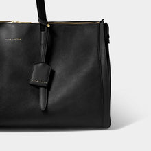 Load image into Gallery viewer, A black bag with a black luggage tag , on a white background.