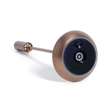 Load image into Gallery viewer, Bottom view of the slim rechargeable table light in a brushed copper finish, showing the circular underside with a black charging interface and power bottom, displayed against a white background.