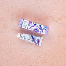 Load image into Gallery viewer, Lollia hand cream packaging and tube of cream on a beige surface