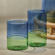 Load image into Gallery viewer, A set of two-toned glasses with blue and green colors with a beige background.