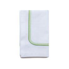 Load image into Gallery viewer, A white cotton napkin with three green  embroidered lines on the edge, neatly folded.
