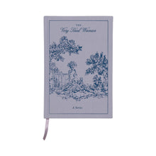 Load image into Gallery viewer, Vintage styled grey journal wrapped in book cloth  with a blue illustration of a person sitting beside a fence and trees. Journal has a champagne colored ribbon bookmark. "THE Very Tired Woman" in blue text at the top of the journal , and "A Series" in blue text at the bottom of the journal. On a white background.