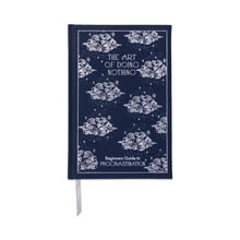 Load image into Gallery viewer, A navy colored journal with a white border and whimsical cloud design. "THE ART OF DOING NOTHING" in white text at the top of the journal and "Beginners Guide to PROCRASTINATION" in white text at the bottom of the journal. Champagne colored ribbon bookmark. On a white background.