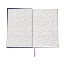 Load image into Gallery viewer, Navy -colored journal opened to white pages with blue designs. Champagne- colored ribbon bookmark. Against a white background.
