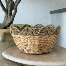 Load image into Gallery viewer, Handwoven seagrass bowl with scalloped rim displayed on round pedestal.