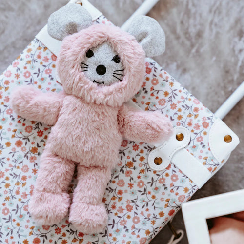 Gray plush mouse with black embroidered facial features and large rounded gray ears, paired with a soft pink fuzzy body and hood, displayed on a mini pink floral suitcase, against a beige background.