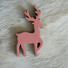Load image into Gallery viewer, Pink Dancing Deer, overhead view of a pink mango wood deer with branching antlers, one raised front leg, and visible natural wood edges, lying on white fur.