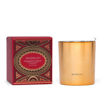 Load image into Gallery viewer, Metallic gold candle with its decorative garnet red and metallic gold box displayed on a white background. 