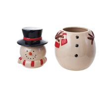 Load image into Gallery viewer, Ceramic ,white, snowman cookie jar with the head placed to the left and the body to the right. The head/ lid features a black top hat with a red stripe, an orange carrot nose, a red and white striped scarf , and black dots for the eyes and mouth. The body/ jar has black dots for buttons, brown branch-like arms, and a red and white scarf. Against a white background. 