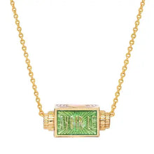 Load image into Gallery viewer, Close-up of the gold-plated rectangular spinner pendant necklace with green enamel and raised lettering, displayed suspended on a white background. 