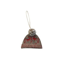 Load image into Gallery viewer, Wool beanie ornament with a white and brown pom-pom, brown base, and red knit pattern featuring reindeers and trees. Ornament has a hanging loop and is displayed against a white background. 
