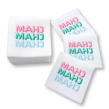 Load image into Gallery viewer, Set of white cocktail napkins printed with the word "MAHJ" in pink, green, and blue, with several napkins fanned out beside a stacked bundle, displayed on a white surface. 