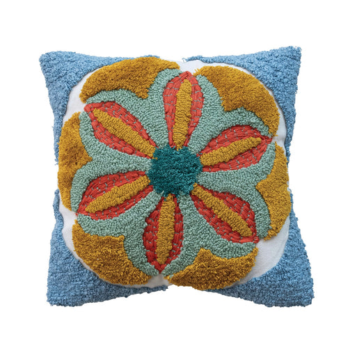 A square-shaped tufted pillow with a floral pattern in blue, red, and yellow colors. On a white background.