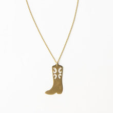 Load image into Gallery viewer, A brass necklace with a cowgirl boot pendant, against a white background.