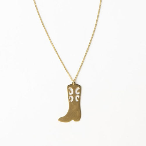 A brass necklace with a cowgirl boot pendant, against a white background.