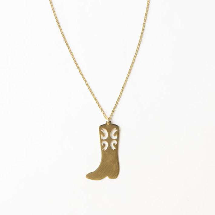 A brass necklace with a cowgirl boot pendant, against a white background.
