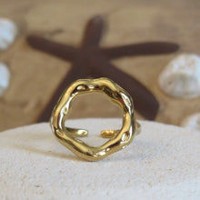 Load image into Gallery viewer, Gold ring on a textured surface with a starfish in the background