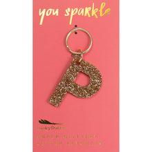 Load image into Gallery viewer, Gold glittery letter &quot;P&quot; keychain on pink card with &quot;you sparkle&quot; in gold text, displayed against a white background.