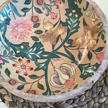 Load image into Gallery viewer, Decorative enamel bowl with a pink, white,  tan, and  green floral design on a woven surface.