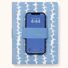 Load image into Gallery viewer, A notebook with a blue and white design and a blue cell phone holder in the middle, with a cell phone inside it. Cell phone has a blue screen and shows the time &quot;4:44&quot;. Notebook is on a white background. 