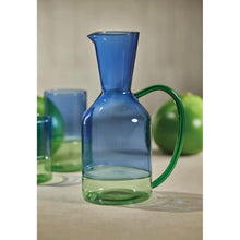 Load image into Gallery viewer, A set of two-toned glassware with blue and green colors, including a tall pitcher, a highball glass and lime on a beige  background.