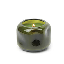 Load image into Gallery viewer, Green tinted glass candle holder with lit candle, on a white background.