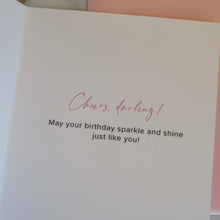Load image into Gallery viewer, Greeting card with &quot;Cheers, darling! May your birthday sparkle and shine just like you!&quot; message on a pink and white background.