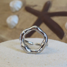 Load image into Gallery viewer, Silver ring on textured surface with starfish in background