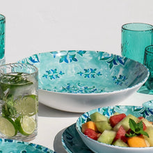 Load image into Gallery viewer, Melamine serving bowl with a turquoise interior and blue floral pattern, styled with matching dinnerware, glasses, and fruit on a white surface against a white background. 