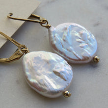 Load image into Gallery viewer, Pearl earrings with gold hooks on a light background