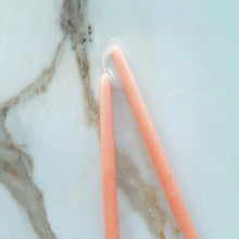 Load image into Gallery viewer, Close-up of two hand dipped blush pink taper candles with white wicks on a marble surface.