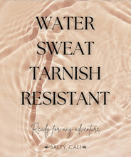 Load image into Gallery viewer, Text &quot;WATER SWEAT TARNISH RESISTANT Ready for any adventure&quot; on a textured beige background with &quot;Salty Cali&quot; branding.
