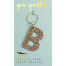 Load image into Gallery viewer, Gold glittery letter &quot;B&quot; keychain on a light blue card with &quot;you sparkle&quot; in gold text, displayed on a white background. 