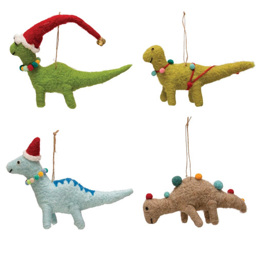 Four felt dinosaur ornaments with pom-pom details. White background. 