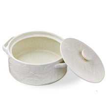 Load image into Gallery viewer, Harvest Round Brie Baking Dish, round warm off-white stoneware dish with a smooth interior, two open handles, and low round lid knob contrasting with embossed leaf designs across the exterior and lid, shown open with the lid leaning against the side, against a white background. 