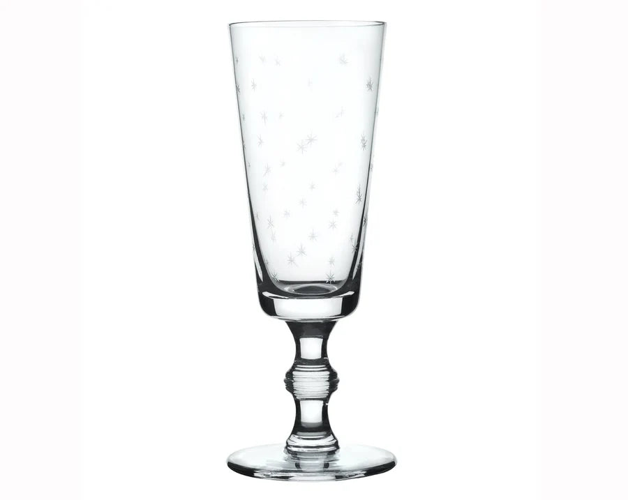Champagne flute with small star etchings. White background. 