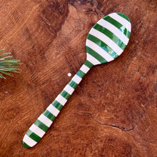 Load image into Gallery viewer, A green and white striped stainless steel spoon , on a brown wooden surface with a green fir tree clipping.
