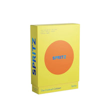 Load image into Gallery viewer, Yellow recipe box with a round orange center and &quot;Spritz&quot; in blue text displayed against a white background. 