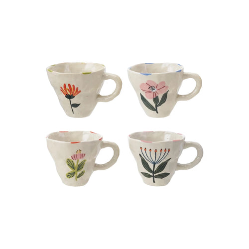A set of four stoneware mugs with various floral patterns in different colors, against a white background.