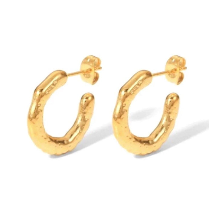 Gold hoop earrings on a white background