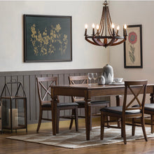 Load image into Gallery viewer, Dining room with wooden table and chairs, chandelier, and wall art.