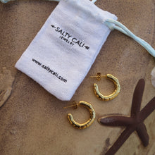 Load image into Gallery viewer, Gold hoop earrings on sand with a &#39;Salty Cali&#39; jewelry pouch.