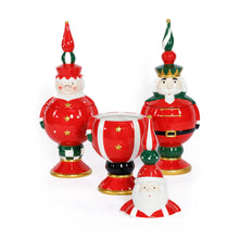 Load image into Gallery viewer, Three hand-painted ceramic holiday cookie jars featuring a Santa Claus, Mrs. Claus, and a nutcracker in red outfits with gold star accents and tall red, green, and white finials, displayed on a white surface with the Santa jar open and its lid placed in front.  