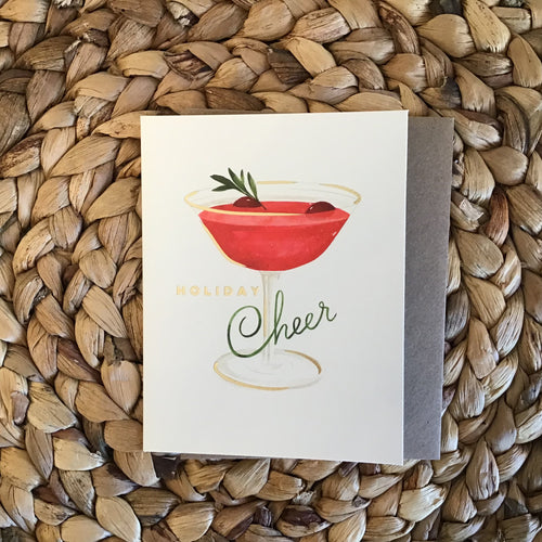 holiday card with holiday drink and gold writing 