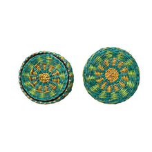 Load image into Gallery viewer, A round woven coaster with a green and yellow pattern and the matching coaster holder with remaining set of coasters on a white background.
