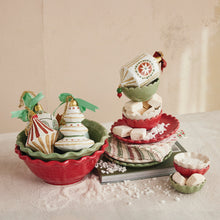 Load image into Gallery viewer, Green and red decorative ceramic bowls with ornaments inside and stack of green and red ceramic dishes with treats on a white surface dusted with white candy and white dust , along a cream background. 