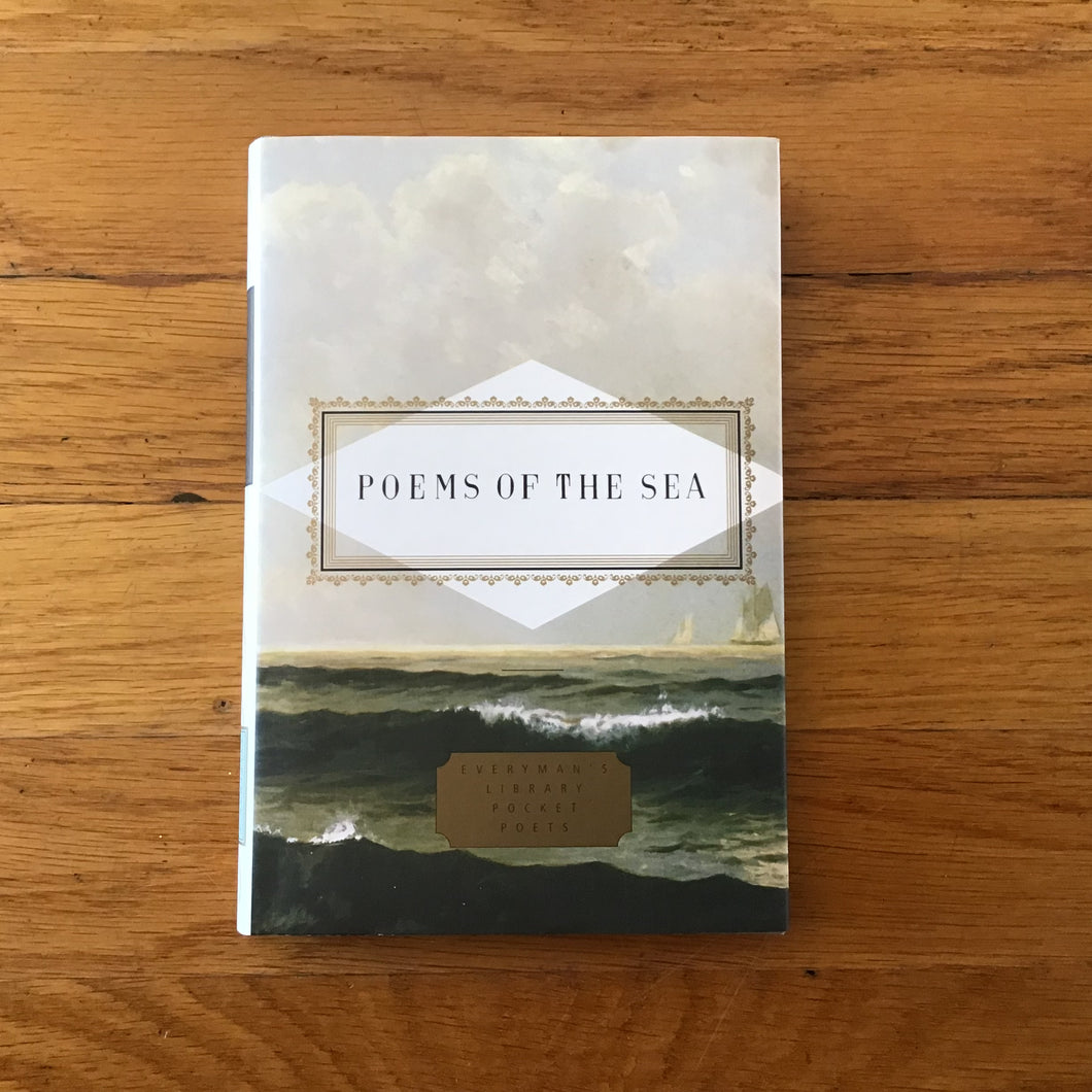Book cover of Poems of the Sea from the Everyman's Library Pocket Poets series featuring an illustration of dark ocean waves under a cloudy sky with a gold decorative border surrounding the title in black lettering. Book displayed on a wooden surface.